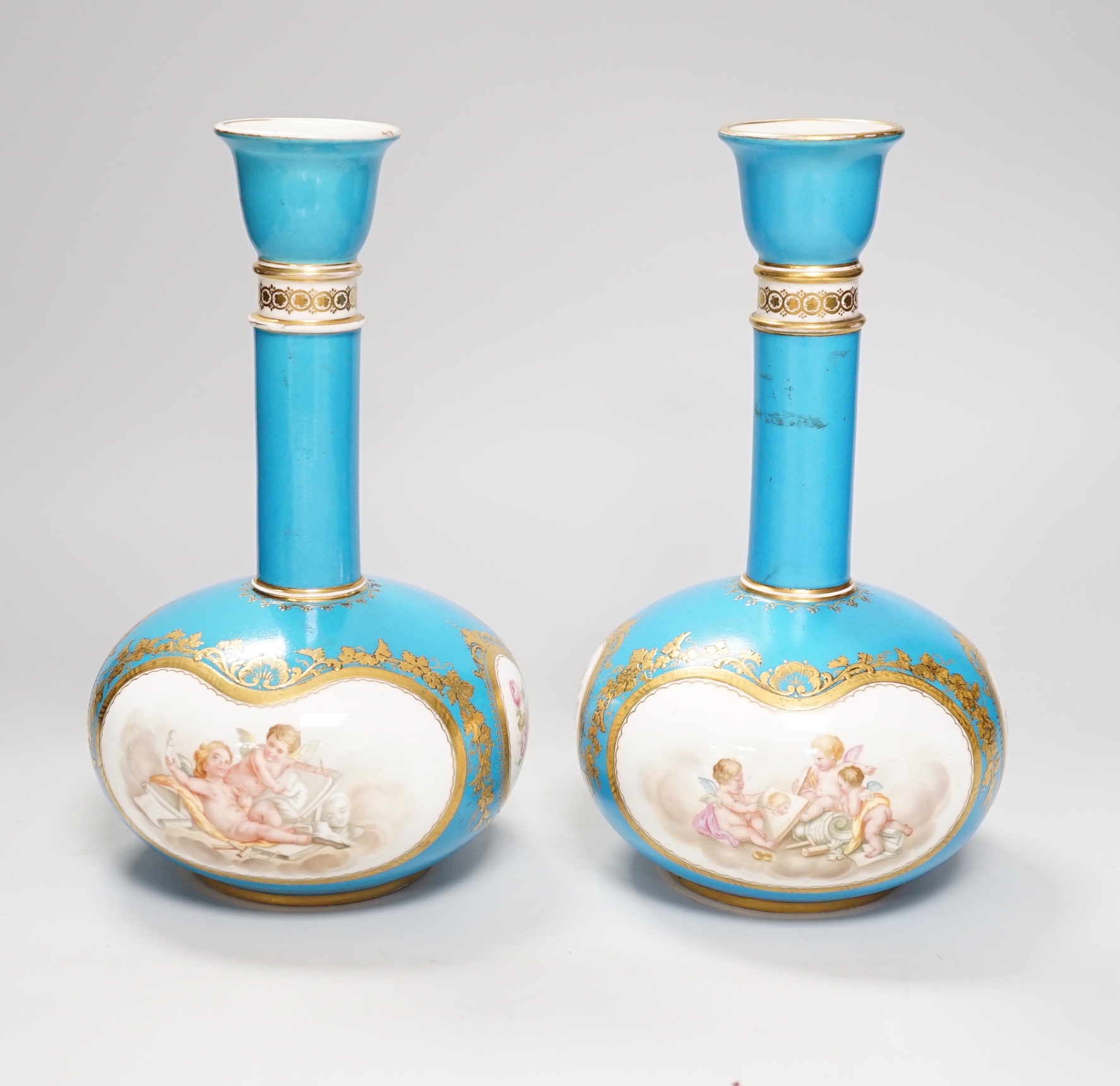 A pair of Coalport turquoise bottle vases, late 19th century, with putti and rose cartouche decoration, gilt CSN mark, 22cm high